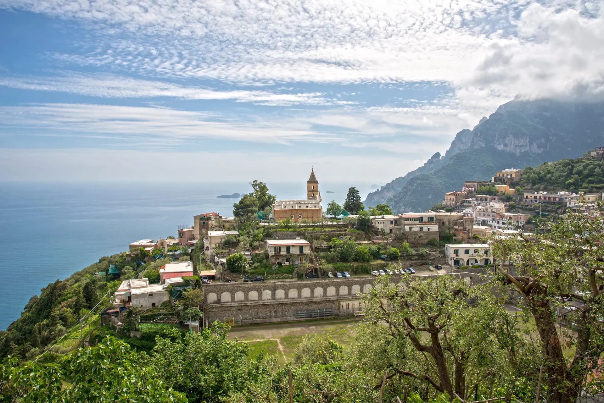 Village of Montepertuso above Positano on steep green hillside overlooking the Mediterranean Sea.